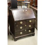 George III Bureau, mixed woods, the drop front opening to a fitted interior, over two short and