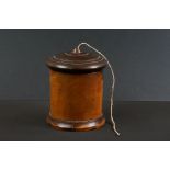 19th Century lignum vitae cylindrical string box with domed screw-down lid, raised on a stepped