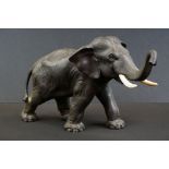 Japanese spelter figure of an Asian elephant, trunk raised, three character marks to base, approx