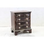 Small Chest of Drawers in the George III style with two short and three long drawers, raised on