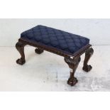 Carved Mahogany Footstool in the Chippendale manner with dark blue upholstered seat and cabriole