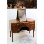 George III Mahogany bow front enclosed Dressing Table, the central hinged lid enclosing a ratchet