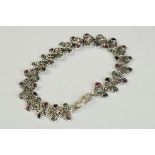 Silver bracelet set with rubies, sapphire & emeralds