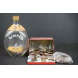 A collection of British sixpence coins contained within a Dimple whisky bottle together with a