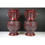 Pair of Chinese Red Glazed Pottery Twin Handled Baluster Vases with relief decoration of stags and a