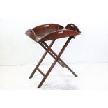 19th century Mahogany Oval Butler's Tray with four fold down flap, raised on a folding stand, 74cm