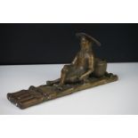 Chinese bronze figure of a fisherman on a bamboo raft, with rod in hand, measures approx 28cm long