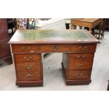 Victorian Walnut Twin Pedestal Writing Desk with green leather inset top and an arrangement of