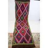 An old hand knotted wool Suzni kilim runner, measures approx 284cm x 80cm
