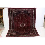 Kurdish Red Ground Wool Rug with central gul surrounded by stylised animals and flowers within a