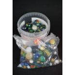 A collection of mainly contemporary marbles of varying sizes.