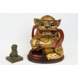 A Chinese carved wooden monkey with gilt decoration together with a Chinese bronze ink stamp