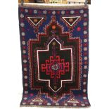A hand knotted wool new Baluchi rug, measures approx 139cm x 88cm