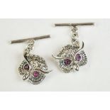 Pair of silver cufflinks in the form of owls with ruby eyes