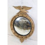 20th century Atsonea Gilt finish Circular Convex Wall Mirror in the Regency style surmounted by an