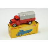 Boxed Dinky 413 Austin Covered Wagon diecast model in red with grey cover, showing play wear, mainly