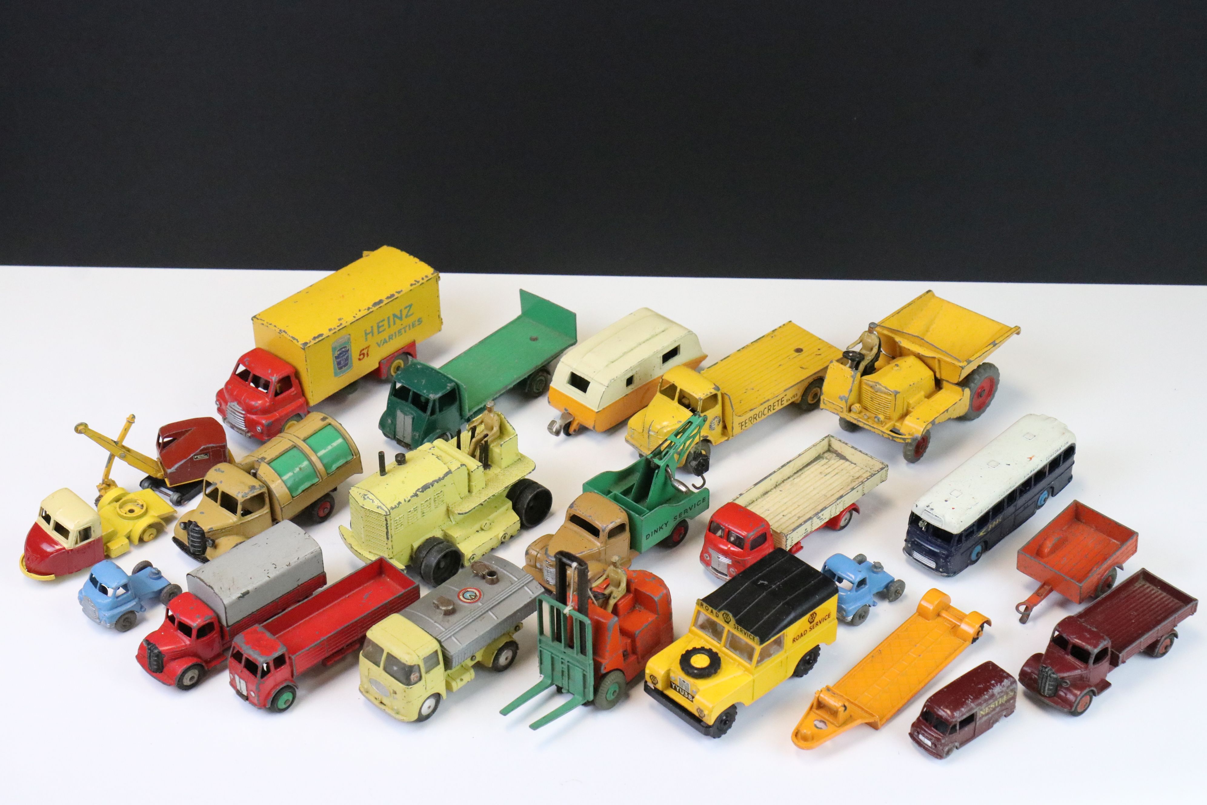 Around 20 mid 20th C play worn diecast models, featuring Dinky, Corgi, Budgie & Matchbox Lesney, all