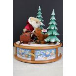 Steiff ' Santa and his Reindeer ' clockwork musical carousel, raised on a cylindrical wooden base,