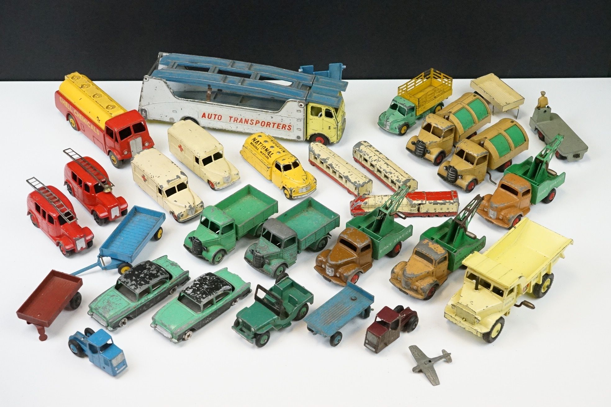 Around 27 mid 20th C play worn Dinky diecast models to include 984 Supertoys Car Carrier, 2 x