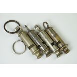 A Collection Of Four British Military Issued Whistles To Include Air Raid Precautions Examples.