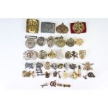 A Group Of Approx Forty Pieces Of Military Collectables To Include Badges And Buckles.