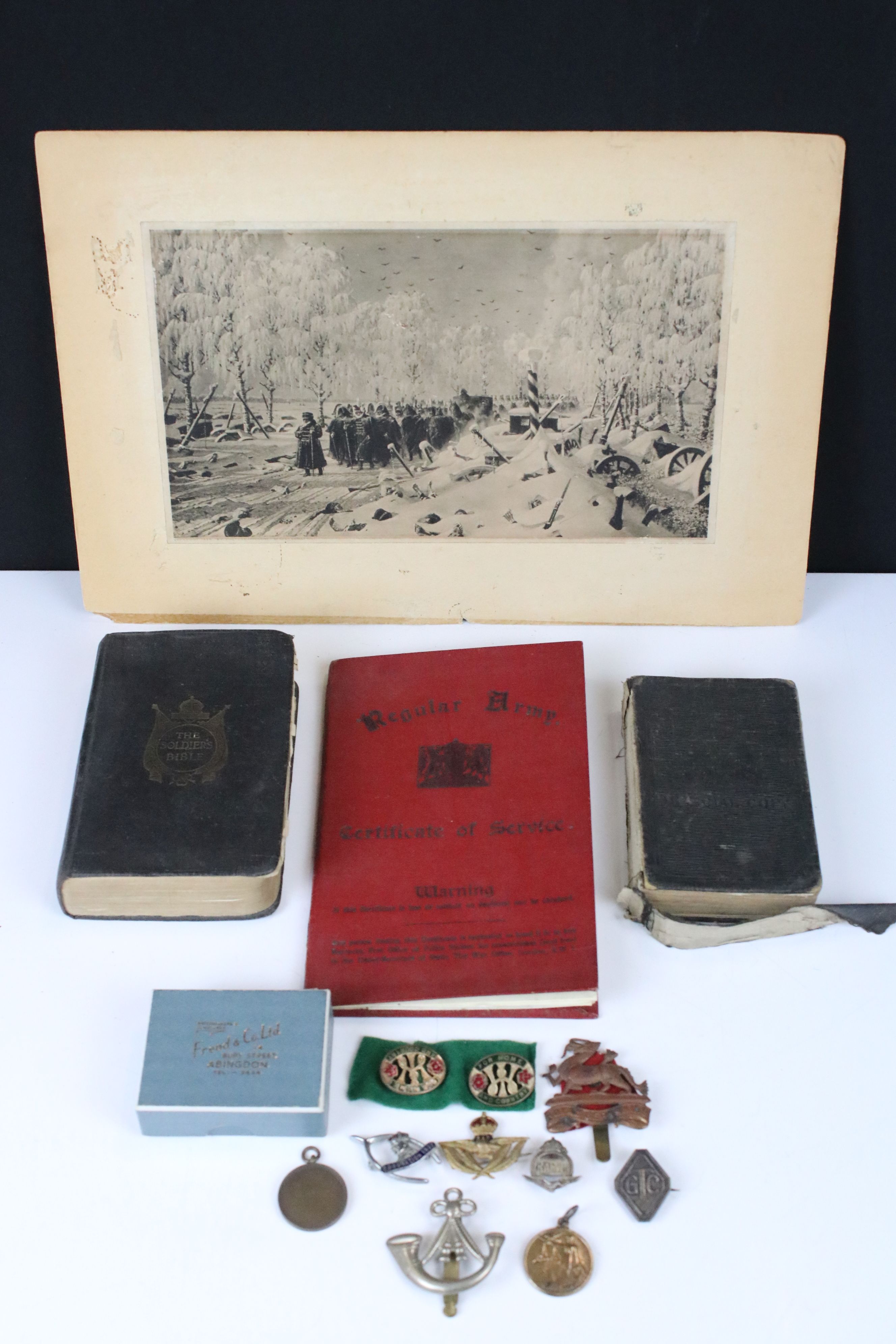 A Group Of Mixed Military Collectables To Include A British Army Service Book, Badges, Bibles And