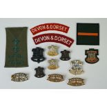 A Collection Of Fourteen British Military The Devon & Dorset Regiment Badges To Include Shoulder