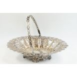 Victorian silver swing handled bon bon dish, pierced body, repoussé foliate and flower head