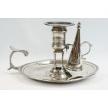 Georgian silver chamberstick with conical snuffer, banded rim, scrolled handle, engraved crest to