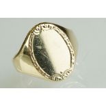 9ct yellow gold signet ring, oval plain polished head with decorative surround, dimensions approx