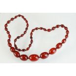 Cherry amber Bakelite necklace, graduated beads, the largest measuring approx 30mm x 21mm, the