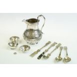 Victorian silver jug of footed baluster form, with embossed eastern-influence scrolling & foliate