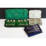 Edwardian cased set of 12 silver teaspoons & sugar tongs with engraved scrolling decoration (