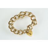 9ct yellow gold curb link bracelet with padlock clasp, every few linkn stamped with the crown and