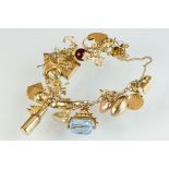 9ct yellow gold charm bracelet, thirteen 9ct golf charms, six yellow metal charms and one 22ct