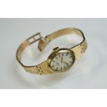 Rotary 9ct yellow gold ladies wristwatch, oval champagne dial, black enamelled gilt baton numerals