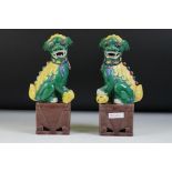 Pair of 20th Century Chinese ceramic Dogs of Foo figures in green and yellow glaze, raised on