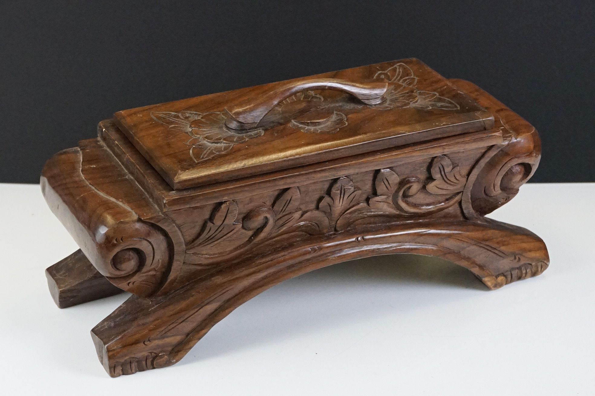 20th Century carved hardwood table-top lidded spice box, with foliate decoration, the lid opening to