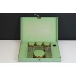 Art Deco Green Enamelled Dressing Case fitted with glass and metal dressing jars, 25cm wide