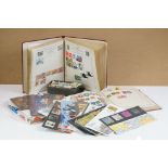 A small collection of British and world stamps contained within three albums together with a small