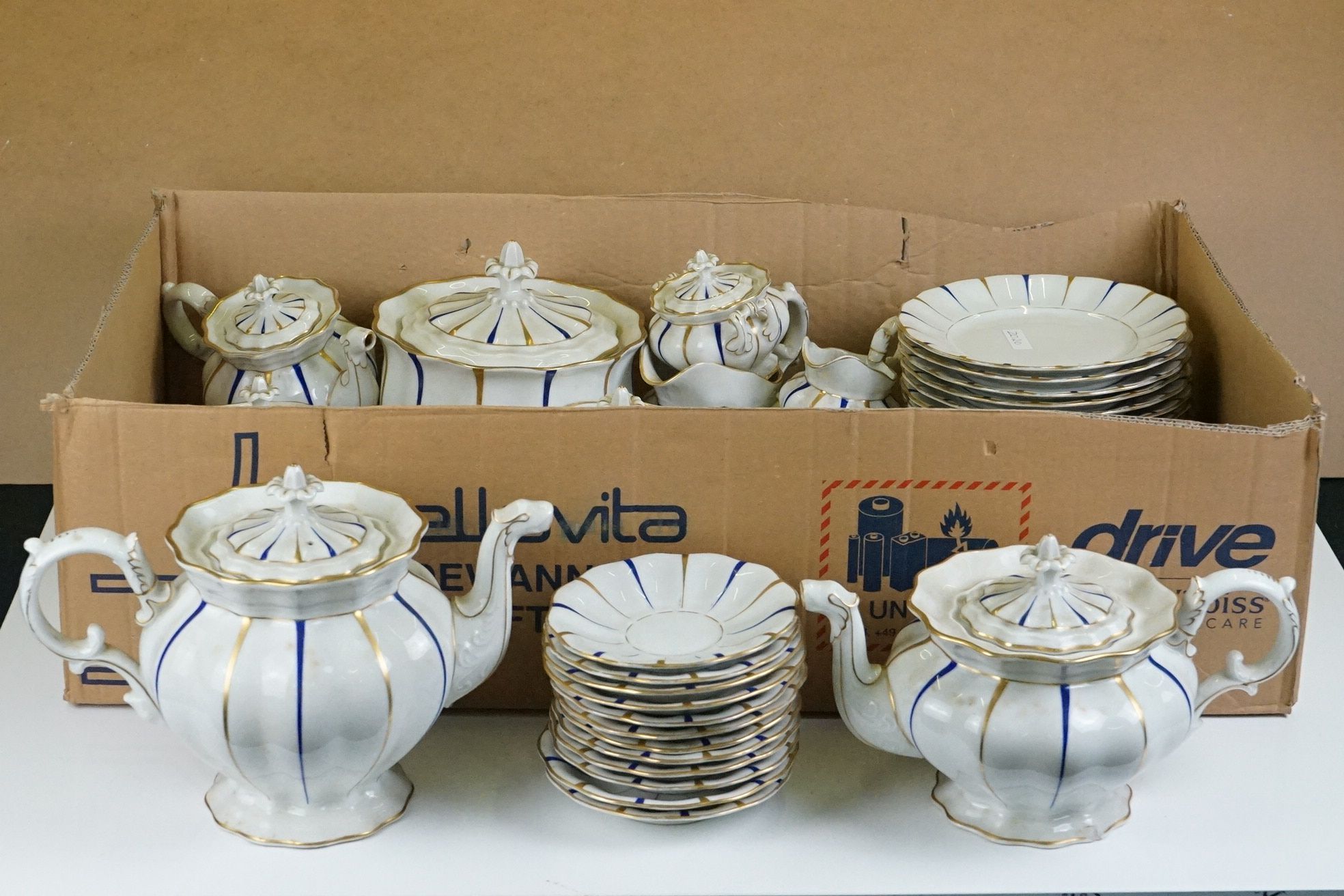 Early 20th Century Furstenberg porcelain tea set of scalloped form, decorated with blue & gilt