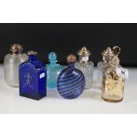 Group of seven glass perfume & scent bottles to include a pair of wrythen form with white metal lids