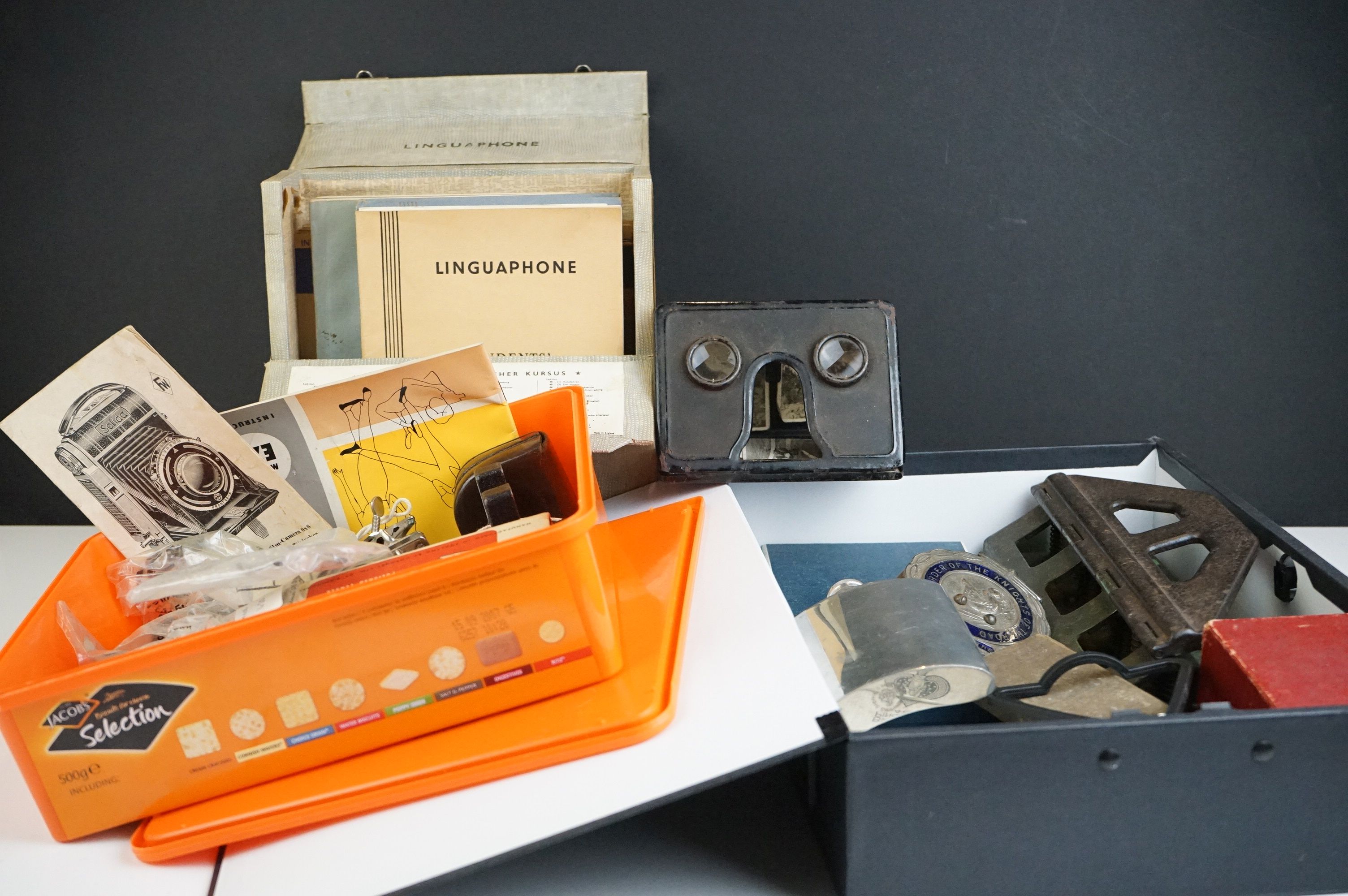 A group of mixed collectables to include coins, car badges, light meter, snuff box, magnifying glass