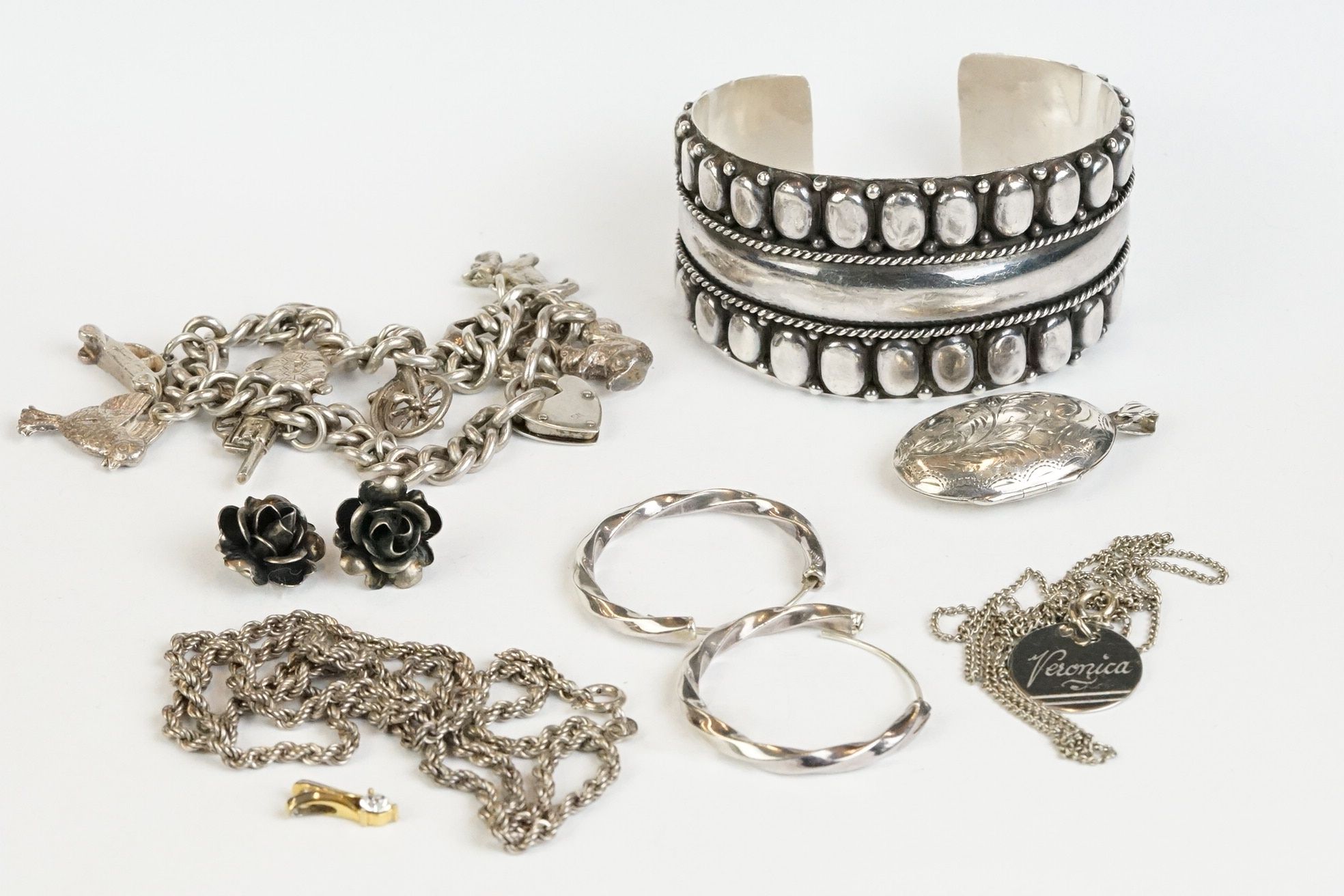 A small collection of sterling silver jewellery to include a bangle, locket, earrings, necklace