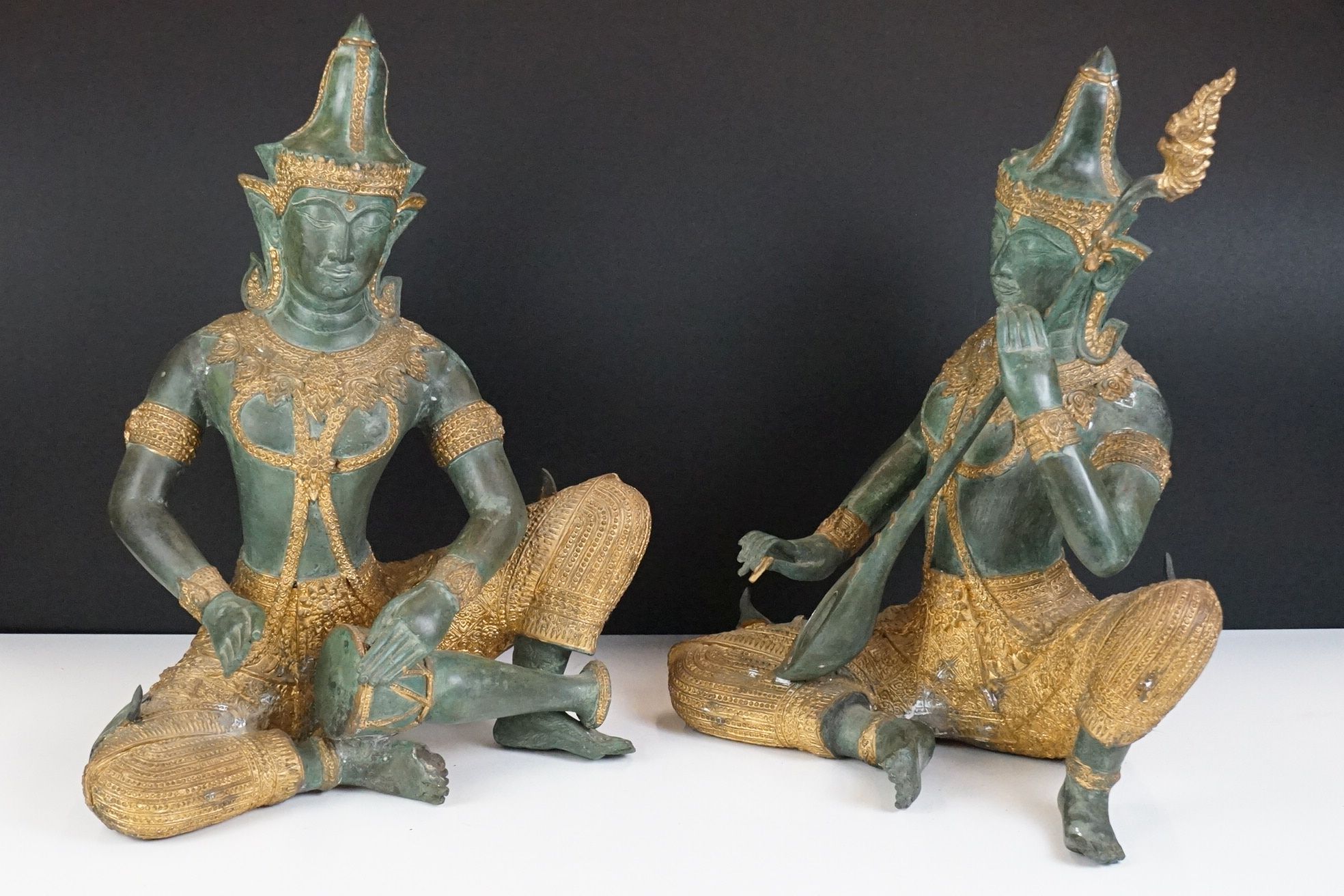 Pair of Thai bronze & gilt sculptures of deities playing musical instruments, one playing a Sueng,