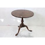 George III Oak Circular Tilt Top Pedestal Table raised on three splayed legs, 75cm diameter x 69cm