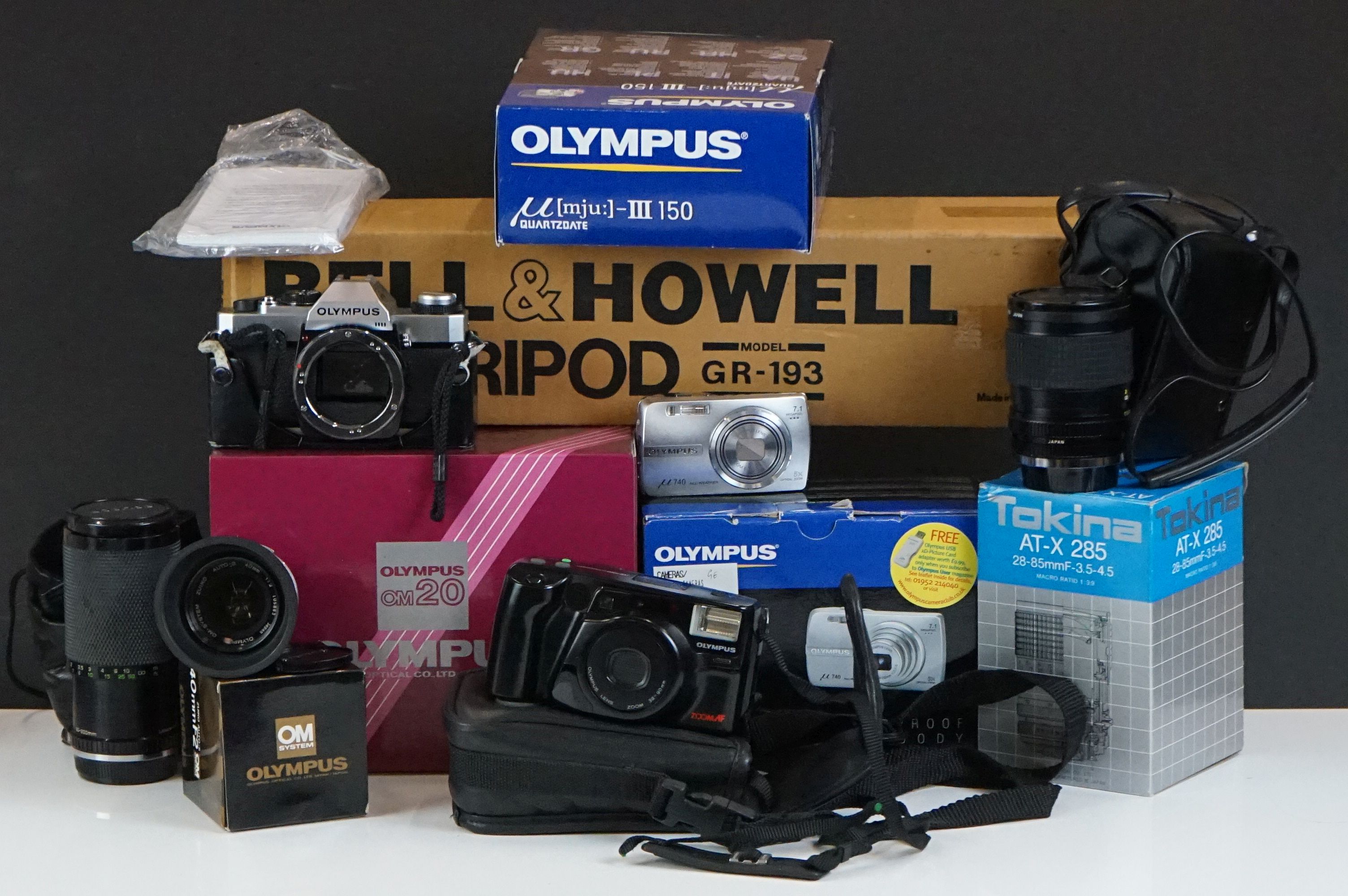 A collection of photography equipment to include an Olympus OM20 camera with Zuiko Auto-S 40mm lens,