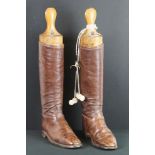 Pair of brown leather polo riding boots with wooden trees, plus a pair of turned bone boot pulls.