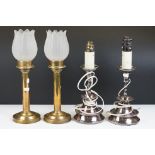 Pair of early 20th century brass spring-loaded candlesticks with frosted glass floral shades, 37cm