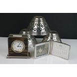 An Art Deco style metal cased clock with faux tortoiseshell front together with a white metal